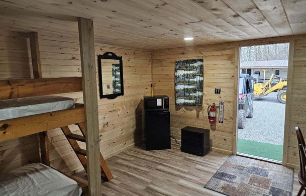 Rustic Cabin interior with bunk beds and mini-fridge